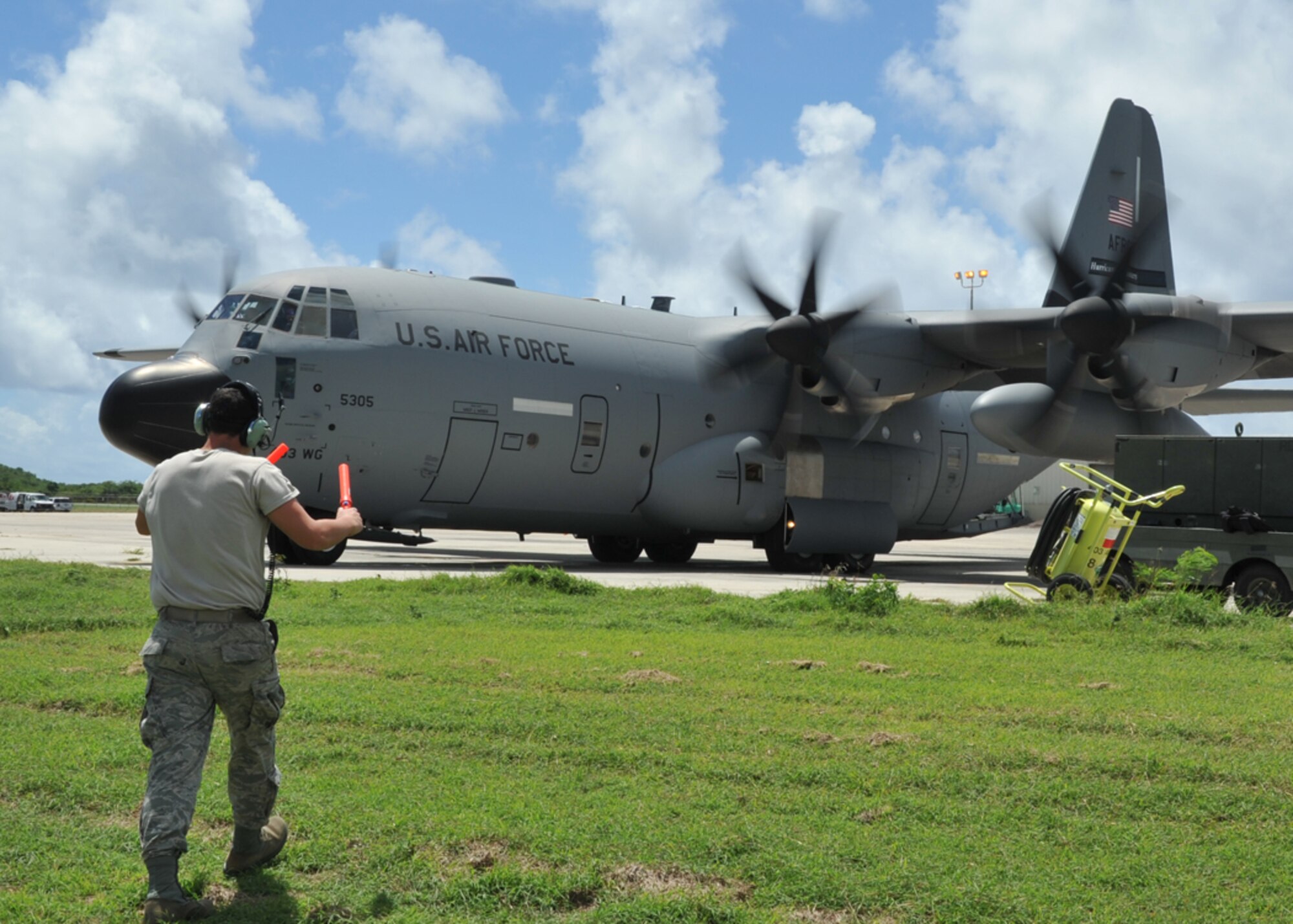 Airman 1st Class Chad Alley, 403rd Aircraft Maintenance Squadron, marshals a WC-130J preparing to takeoff from the Henry E. Rohlsen Airport in St. Croix, U.S. Virgin Islands Aug. 25, 2014. Alley, a reservist at Keesler Air Force Base, Mississippi, is deployed to St. Croix to assist the 53rd Weather Reconnaissance Squadron. The Hurricane Hunters have been flying storm missions into Hurricane Cristobal since Aug. 21, 2014. (U.S. Air Force photo/Maj. Marnee A.C. Losurdo)