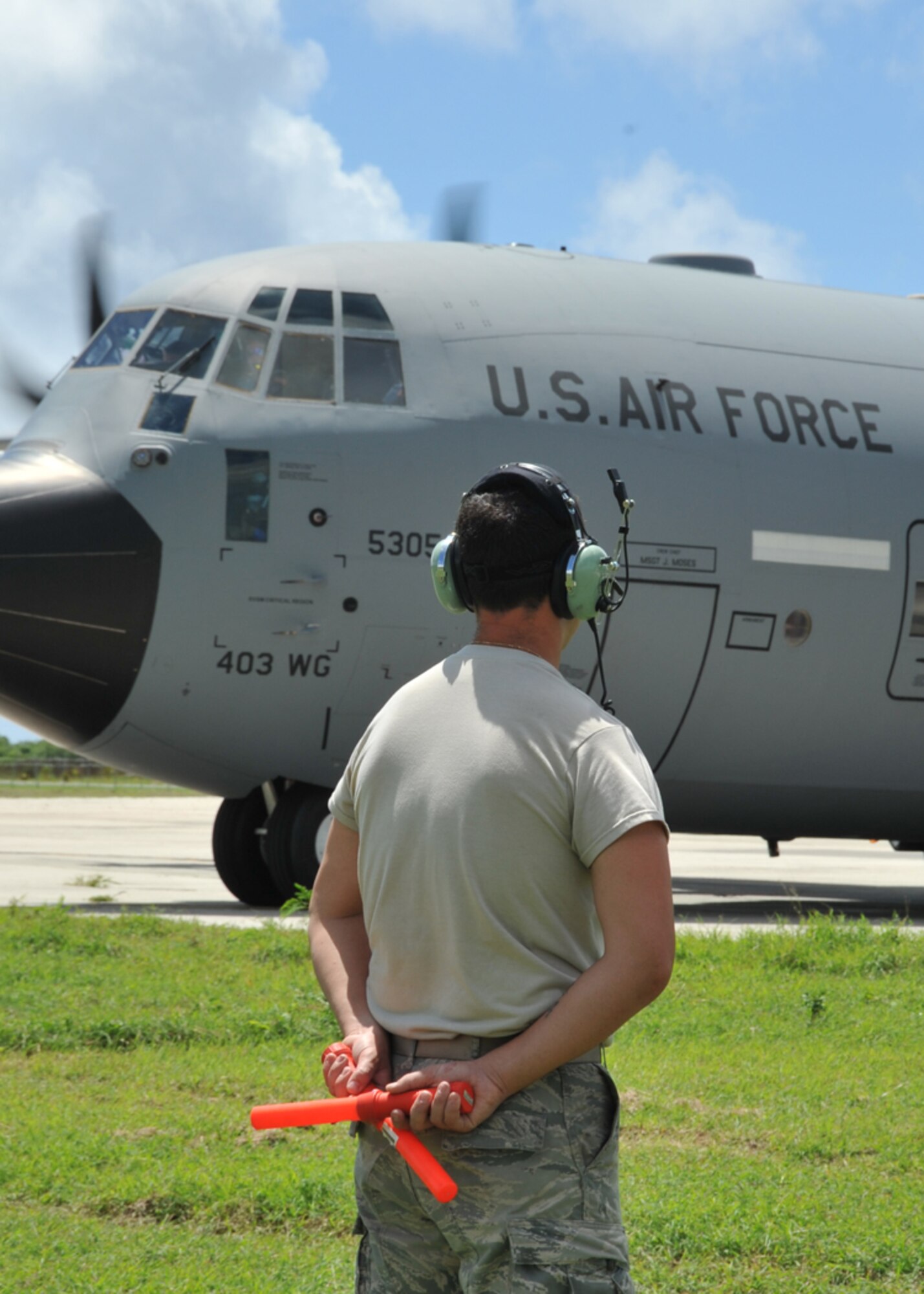 Airman 1st Class Chad Alley, 403rd Aircraft Maintenance Squadron, marshals a WC-130J preparing to takeoff from the Henry E. Rohlsen Airport in St. Croix, U.S. Virgin Islands Aug. 25, 2014. Alley, a reservist at Keesler Air Force Base, Mississippi, is deployed to St. Croix to assist the 53rd Weather Reconnaissance Squadron. The Hurricane Hunters have been flying storm missions into Hurricane Cristobal since Aug. 21, 2014. (U.S. Air Force photo/Maj. Marnee A.C. Losurdo)