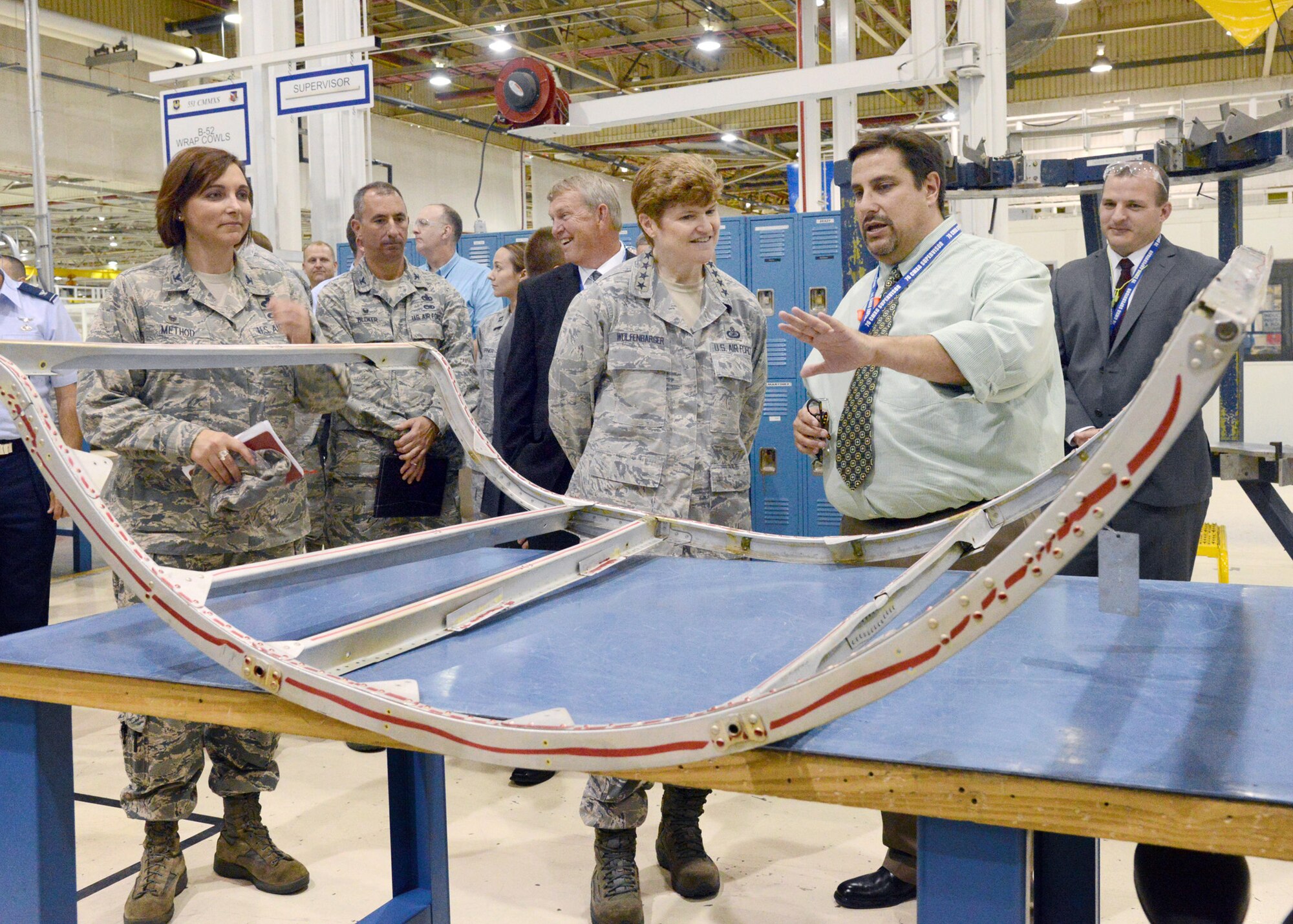 Gen. Janet Wolfenbarger, commander of Air Force Materiel Command toured Tinker Air Force Base Tuesday and Wednesday with members of the AFMC Community Liason Program. David Deal, with the 551st Commodities Maintenance Squadron, briefed the group  on the local manufacturing process for B-52 wrap cowls. The 19 members  of the CLP group represent communities surrounding AFMC installations across the United States. (Air Force photo by Kelly White)