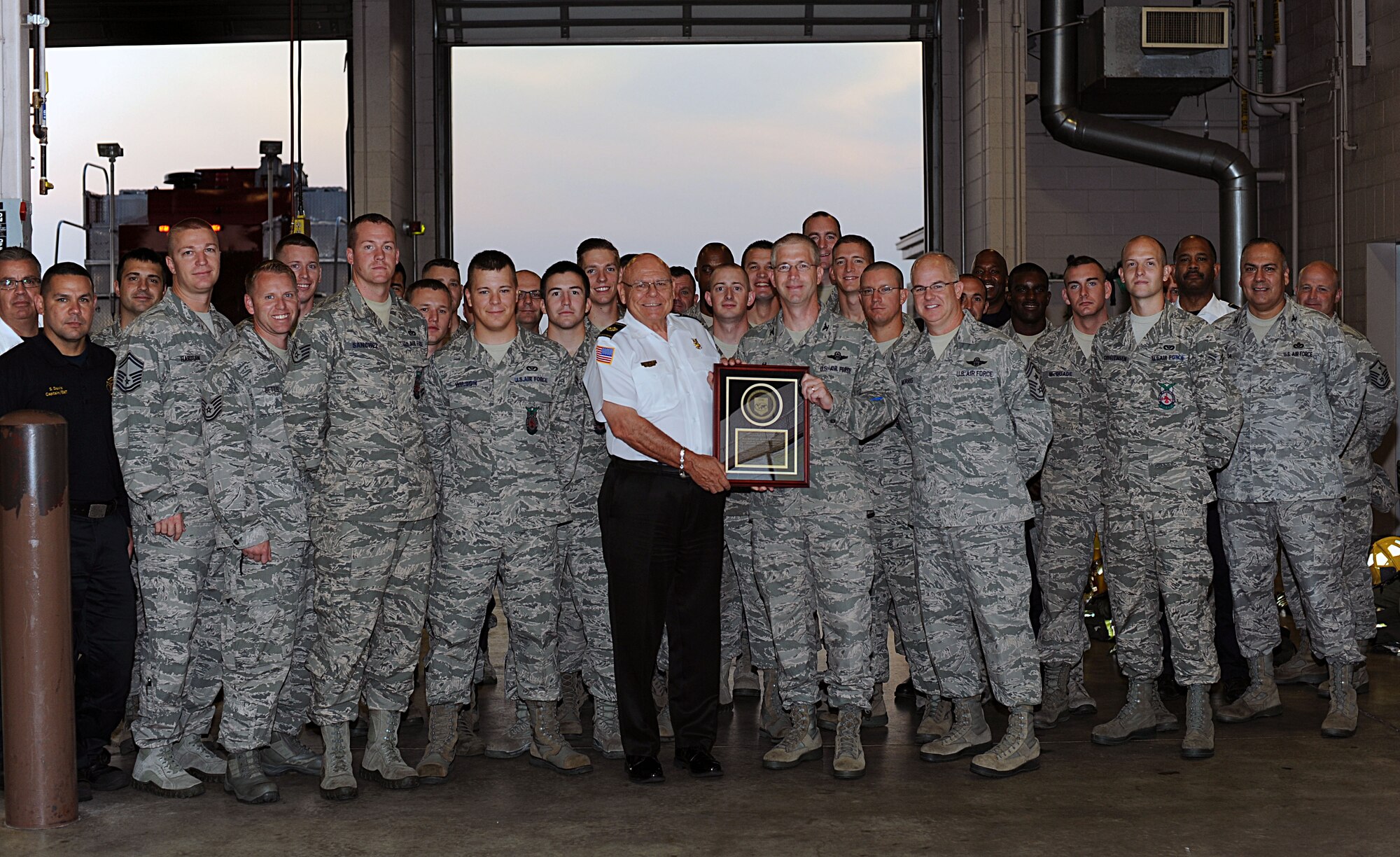 The 22nd Civil Engineer Squadron Fire and Emergency Services Flight receives the Accredited Agency Award from Col. Joel Jackson, 22nd Air Refueling Wing commander, Aug. 27, 2014, at McConnell Air Force Base, Kan. McConnell’s Fire Department earned its accreditation, Aug. 13, 2014, from the Commission on Fire Accreditation International. (U.S. Air Force photo/Airman 1st Class David Bernal Del Agua)