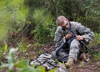 An Army Ranger student cleans his weapon prior during some down time in the woods of the Eglin Air Force Base, Fla., range.  Students complete the final phase of the Army Ranger course with the 6th Ranger Training Battalion.  Instructors expose the students to 18-day field training that includes airborne and helicopter assaults, small boat operations, river and swamp crossings.  (U.S. Air Force photo/Tech. Sgt. Samuel King Jr.)