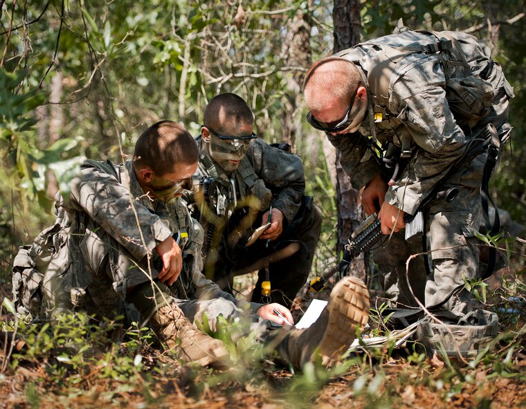 Army Ranger students discuss maneuvers in the woods of the Eglin Air Force Base, Fla., range.  Students complete the final phase of the Army Ranger course with the 6th Ranger Training Battalion.  Instructors expose the students to 18-day field training that includes airborne and helicopter assaults, small boat operations, river and swamp crossings.  (U.S. Air Force photo/Tech. Sgt. Samuel King Jr.)