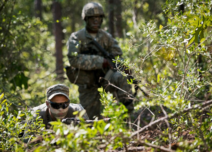 Army Ranger students scan the treeline while on watch duty in the woods of the Eglin Air Force Base, Fla., range.  Students complete the final phase of the Army Ranger course with the 6th Ranger Training Battalion.  Instructors expose the students to 18-day field training that includes airborne and helicopter assaults, small boat operations, river and swamp crossings. (U.S. Air Force photo/Tech. Sgt. Samuel King Jr.)