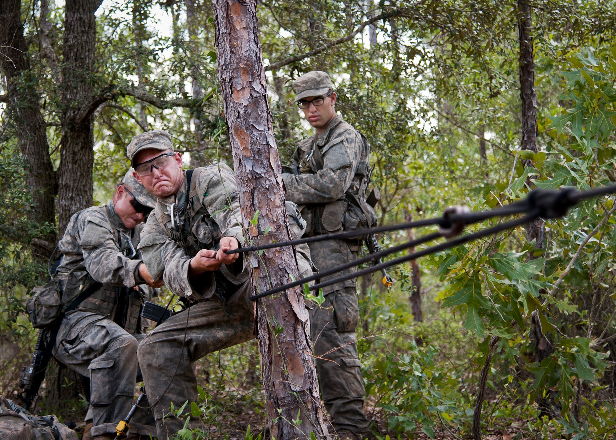 Army Ranger students practice their rope tying procedures prior to a river crossing during a field training exercise in the woods of the Eglin Air Force Base, Fla., range.  Students complete the final phase of the Army Ranger course with the 6th Ranger Training Battalion.  Instructors expose the students to 18-day field training that includes airborne and helicopter assaults, small boat operations, river and swamp crossings. (U.S. Air Force photo/Tech. Sgt. Samuel King Jr.)