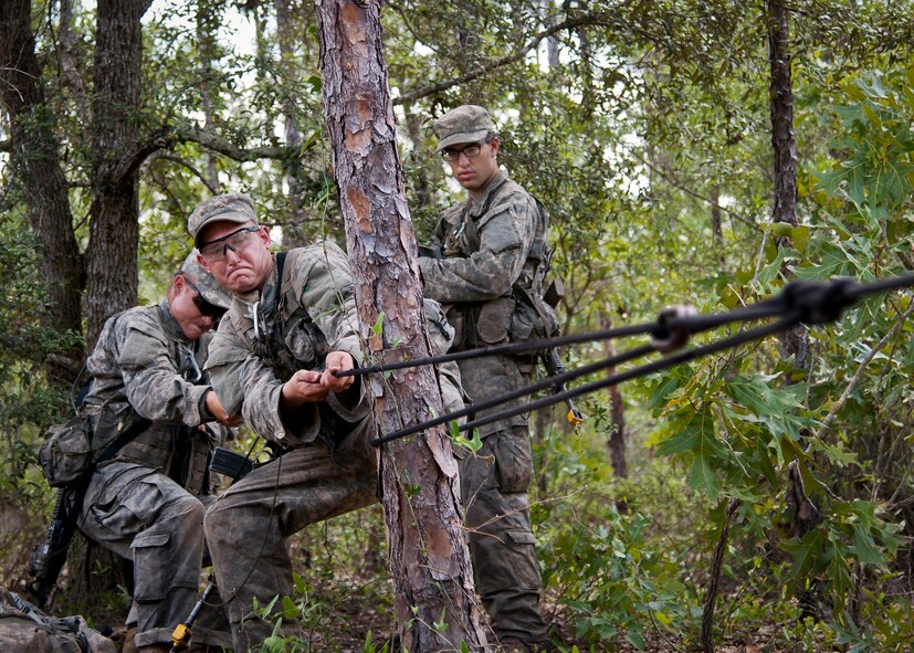 Army Ranger students practice their rope tying procedures prior to a river crossing during a field training exercise in the woods of the Eglin Air Force Base, Fla., range.  Students complete the final phase of the Army Ranger course with the 6th Ranger Training Battalion.  Instructors expose the students to 18-day field training that includes airborne and helicopter assaults, small boat operations, river and swamp crossings. (U.S. Air Force photo/Tech. Sgt. Samuel King Jr.)