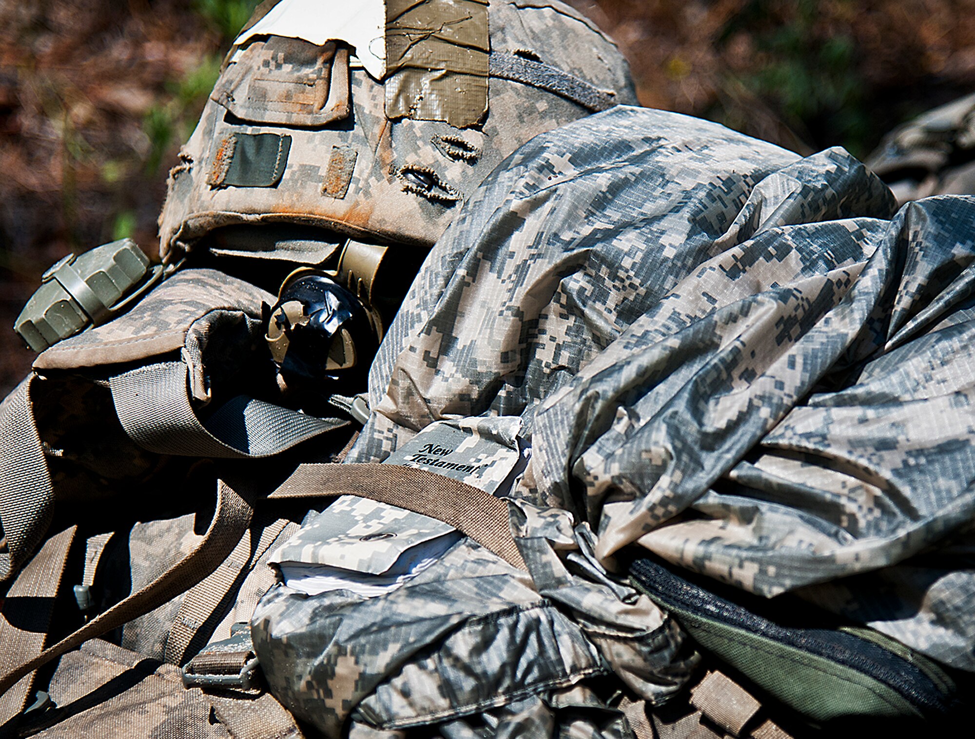 An Army Combat copy of the New Testament is secured with a Ranger student’s gear in the woods of the Eglin Air Force Base, Fla., range.  Students complete the final phase of the Army Ranger course with the 6th Ranger Training Battalion.  Instructors expose the students to 18-day field training that includes airborne and helicopter assaults, small boat operations, river and swamp crossings. (U.S. Air Force photo/Tech. Sgt. Samuel King Jr.) 