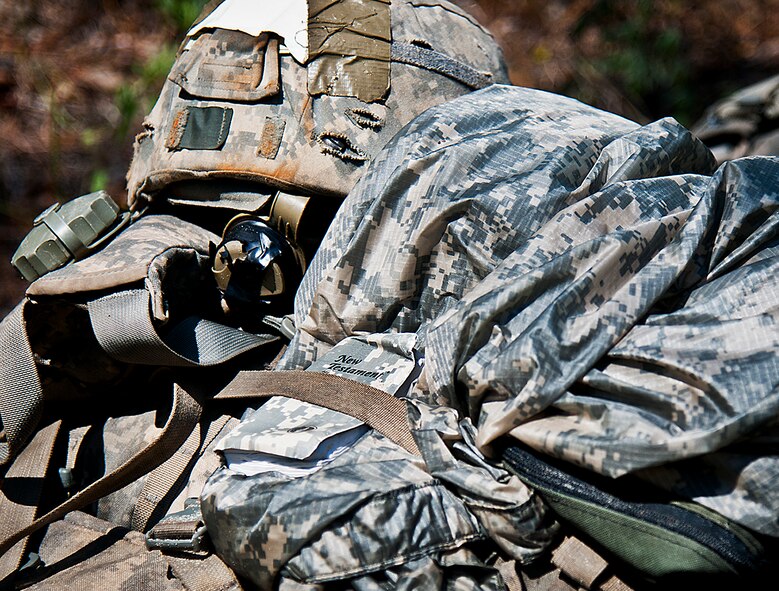 An Army Combat copy of the New Testament is secured with a Ranger student’s gear in the woods of the Eglin Air Force Base, Fla., range.  Students complete the final phase of the Army Ranger course with the 6th Ranger Training Battalion.  Instructors expose the students to 18-day field training that includes airborne and helicopter assaults, small boat operations, river and swamp crossings. (U.S. Air Force photo/Tech. Sgt. Samuel King Jr.) 
