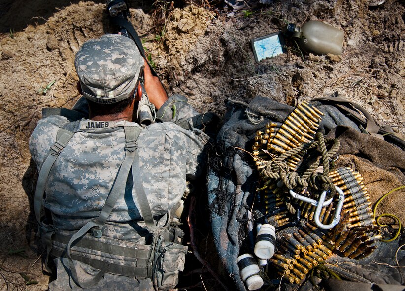 An Army Ranger student scans the treeline while on watch duty in the woods of the Eglin Air Force Base, Fla., range.  Students complete the final phase of the Army Ranger course with the 6th Ranger Training Battalion.  Instructors expose the students to 18-day field training that includes airborne and helicopter assaults, small boat operations, river and swamp crossings. (U.S. Air Force photo/Tech. Sgt. Samuel King Jr.)