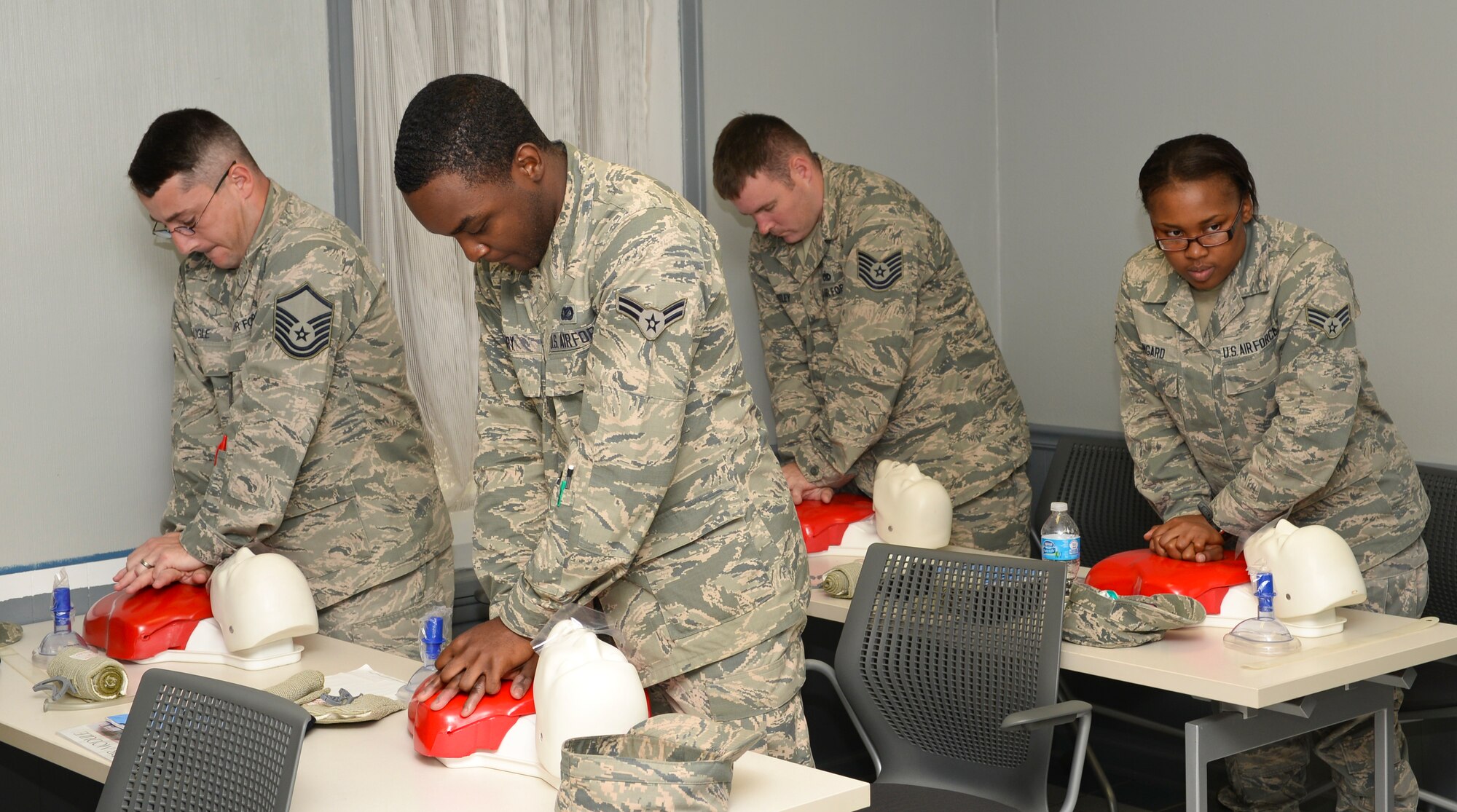 Students practice performing CPR in a self-aid and buddy care training class on Barksdale Air Force Base, La., Aug. 22, 2014. Airmen also learn how to use an automatic electronic defibrillator in order to get the heart to pump blood at a normal beat. (U.S. Air Force photo/Airman 1st Class Benjamin Raughton)