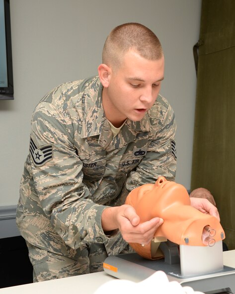 Staff Sgt. Jacob Foster, 2nd Maintenance Group instructor, demonstrates how to open a person's airway on Barksdale Air Force Base, La., Aug. 22, 2014. Foster and others on Barksdale provide self-aid and buddy care training to Airmen because it is an Air Force requirement, and that Airmen have the tools they need to provide immediate emegency care whether in the comfort of home or under fire downrange. (U.S. Air Force photo/Airman 1st Class Benjamin Raughton)