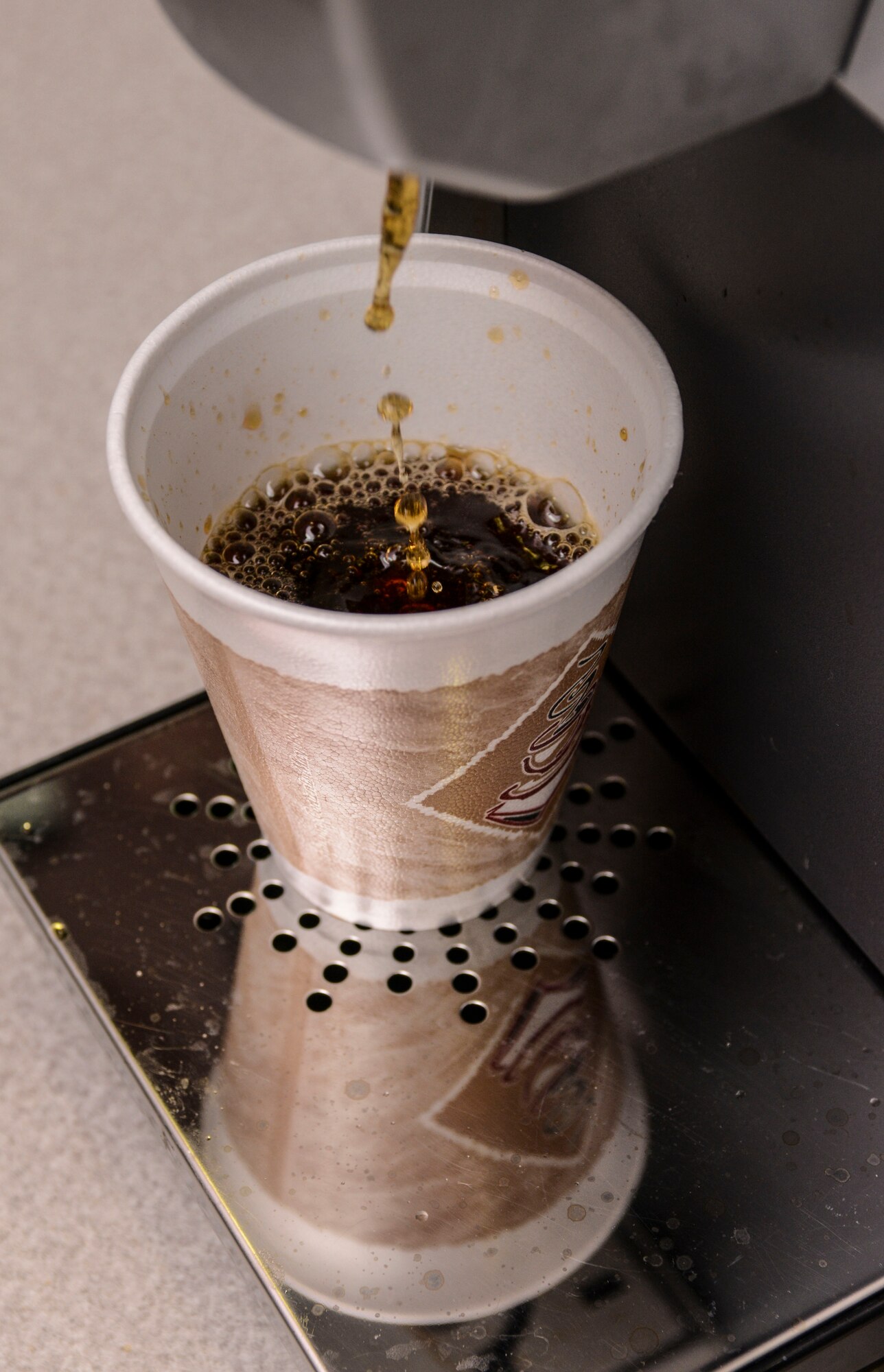 A cup of coffee is filled at the chapel’s free coffee and slushy counter in the McAdoo Sports and Fitness Center on Minot Air Force Base, N.D., Aug. 5, 2014. The counter has offered free beverages since the summer of 2013 and approximately 40 Airmen visit on days it is open. Hours are from 7:30 a.m. to 9 a.m. Tuesday, Wednesday and Thursday. (U.S. Air Force photo/ Senior Airman Stephanie Morris)