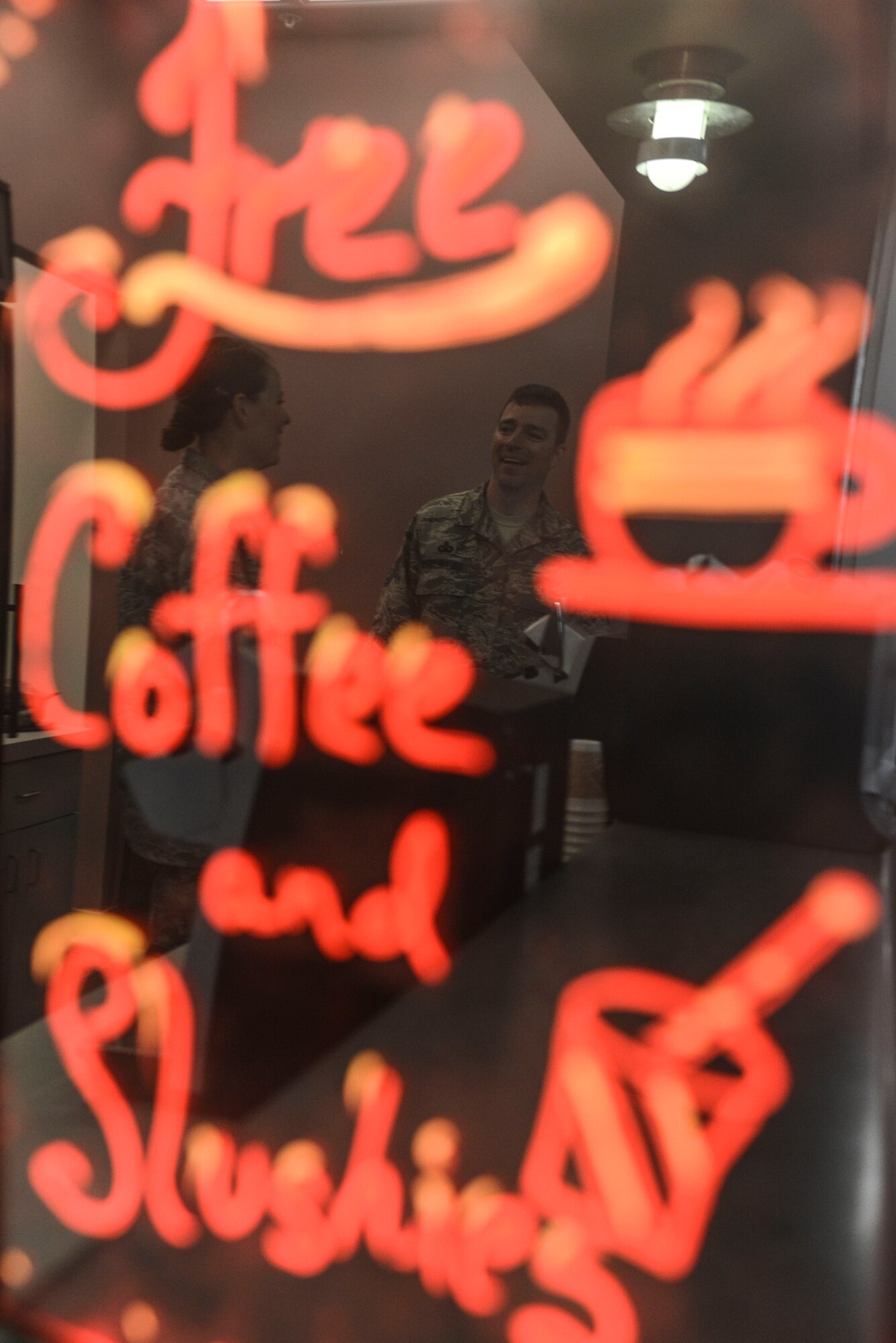 Capt Jayme Kendall, 91st Missile Wing Chaplain and Master Sgt. James Hayes, 5th Bomb Wing chapel assistant, await visitors at the chapel’s coffee and slushy counter in the McAdoo Sports and Fitness Center on Minot Air Force Base, N.D., Aug. 5, 2014. The counter is open from 7:30 a.m. to 9 a.m. Tuesday, Wednesday and Thursday, and offers a variety of free coffee, hot cocoa and two flavors of sports-drink slushies. (U.S. Air Force photo/ Senior Airman Stephanie Morris)