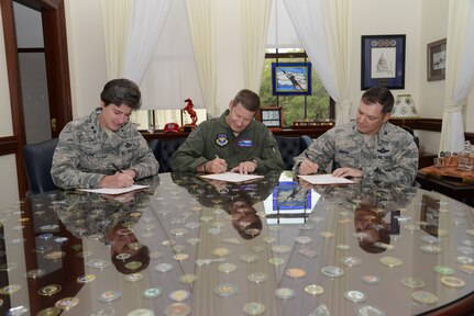 Gen. Robin Rand (center), commander of Air Education and Training Command; Maj. Gen. Margaret Poore (left), commander of Air Force Personnel Center; and Col. Michael Romero, acting commander of Air Force Recruiting Service, sign Combined Federal Campaign contribution forms Aug. 19 in preparation for the CFC kick off Tuesday.
(U.S. Air Force photo by Joel Martinez)
