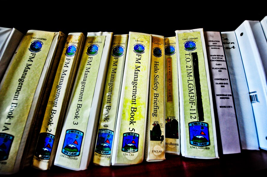 Facility manager binders sit on a book shelf at a missile alert facility in North Dakota. FMs are responsible for the day-to-day operations at a MAF and ensure the Airmen are taken care of at their home away from home. (U.S. Air Force photo/Senior Airman Brittany Y. Bateman)