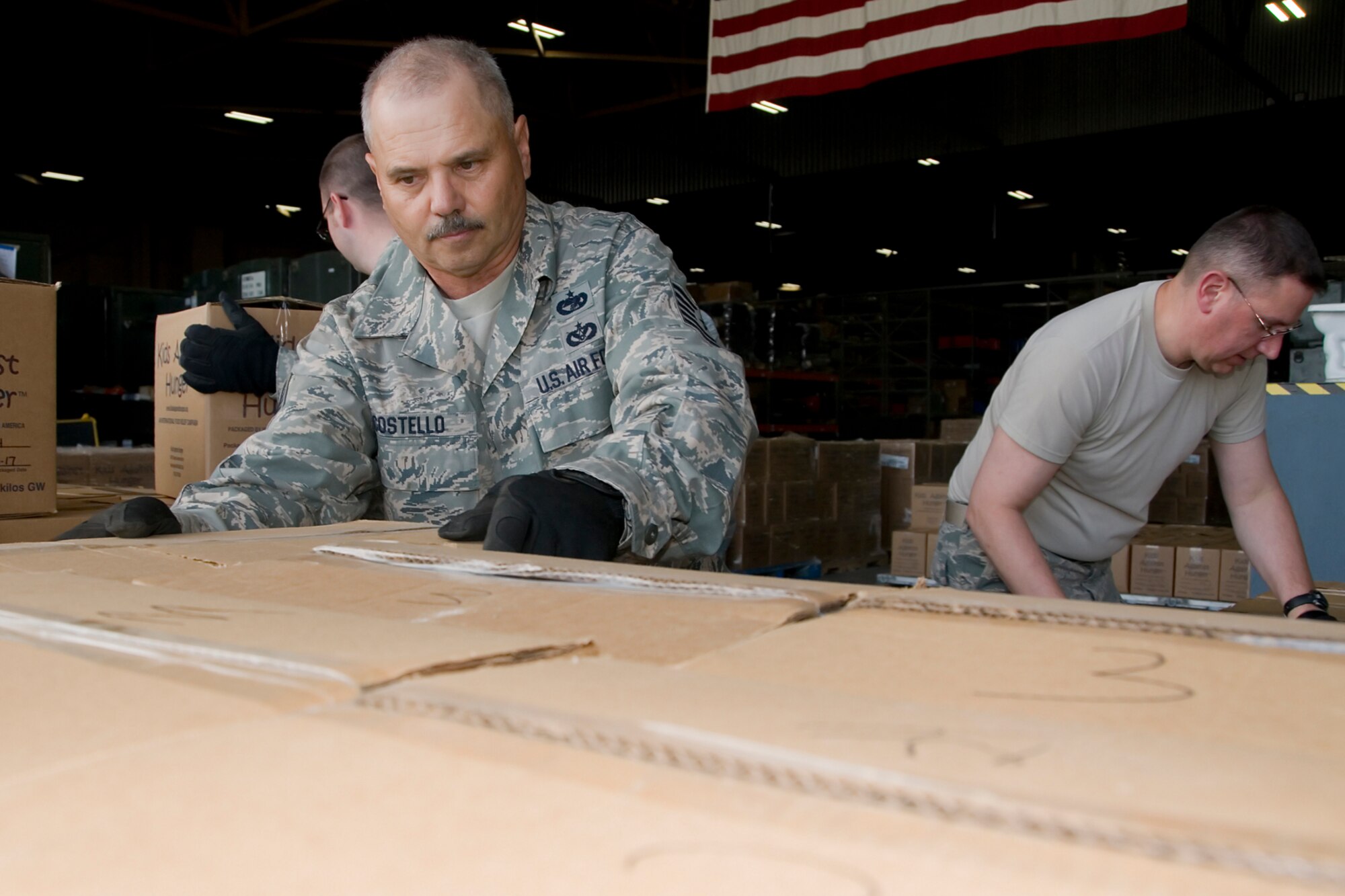 Tech. Sgt. Daniel Costello, 434th Logistics Readiness Squadron vehicle operator, and Tech. Sgt.  Joseph Schluttenhofer, 434th Air Refueling Wing pay technician, palletize boxes to be shipped aboard a KC-10 Extender aircraft at Grissom Air Reserve Base, Ind., Aug 9, 2014. Grissom Air Force reservists teamed up with Airmen from Charleston Air Force Base, S.C., to deliver 91,000 pounds of food, clothes and supplies to Haiti as part of a humanitarian relief mission under the Denton Program. (U.S. Air Force photo/Senior Airman Jami K. Lancette)