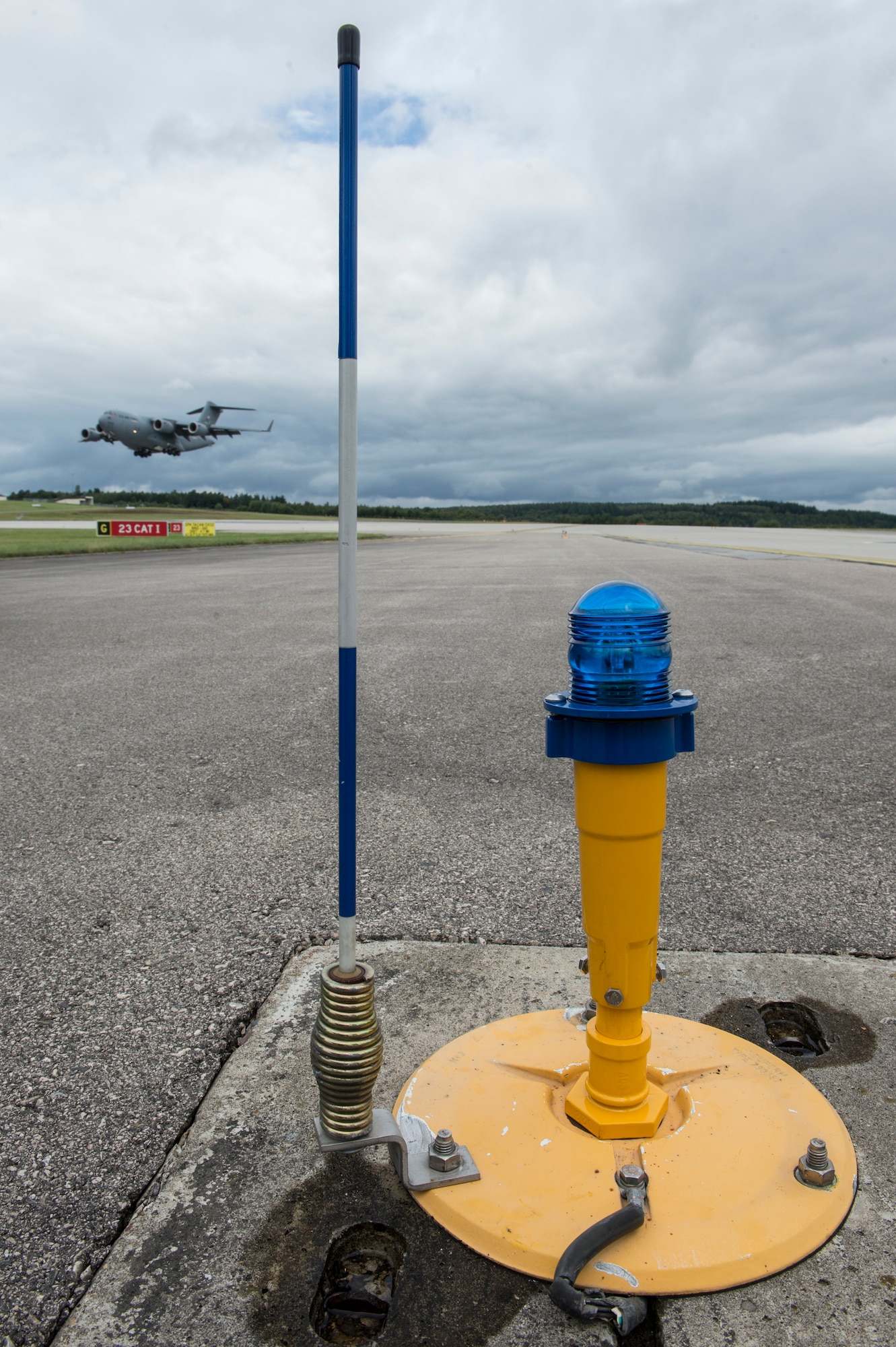 A Light-Emitting Diode taxiway light lines the Spangdahlem airfield Aug. 26, 2014, at Spangdahlem Air Base, Germany. Each LED has a life expectancy of five to seven years compared to the old bulbs that lasted an average of five months. (U.S. Air Force photo by Staff Sgt. Christopher Ruano/Released)