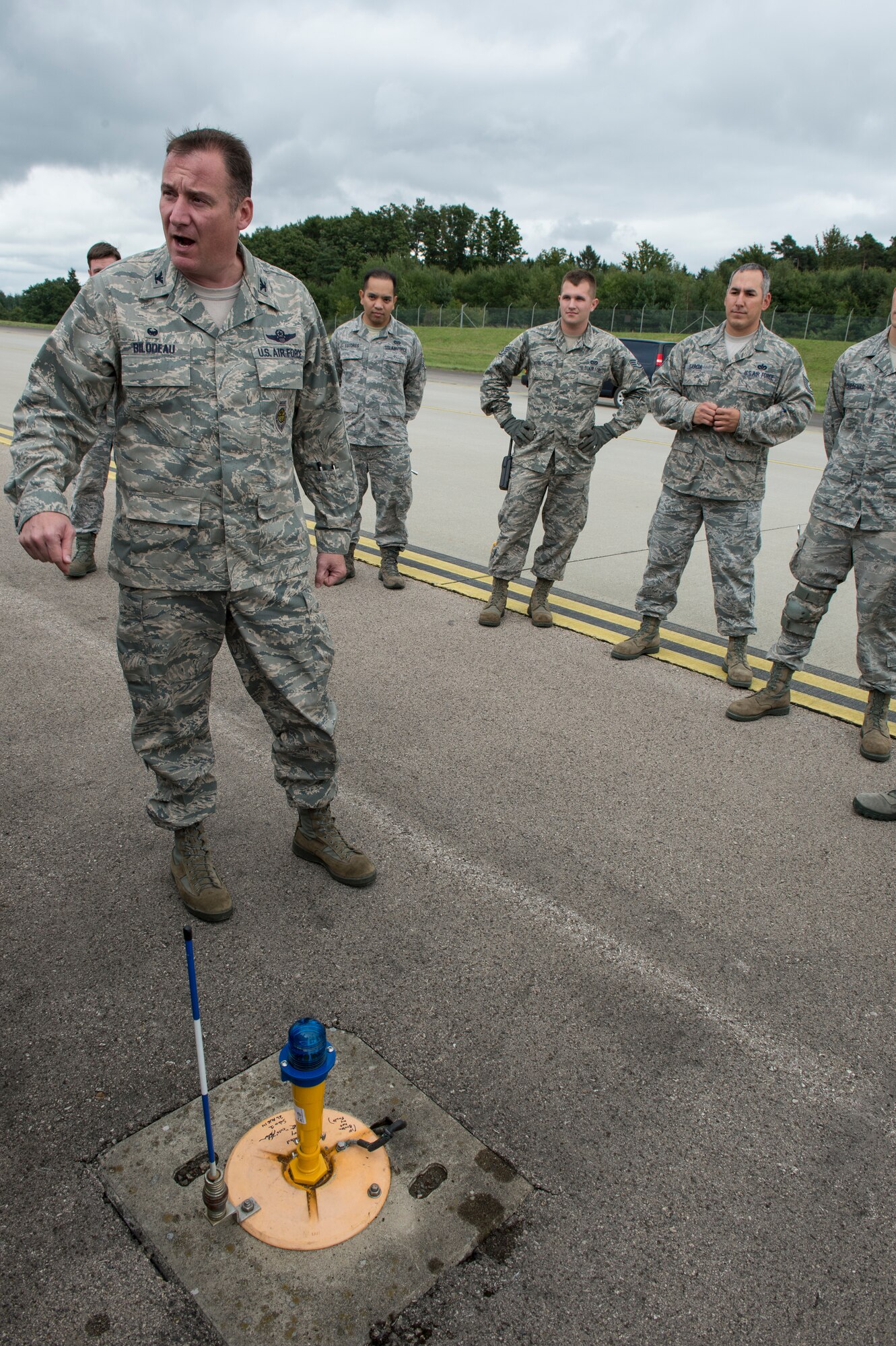 U.S. Air Force Col. Pete Bilodeau, 52nd Fighter Wing commander, thanks Airmen from the 52nd Civil Engineer Squadron for their hard work converting more than 1,000 taxiway lights to energy saving Light-Emitting Diodes Aug. 26, 2014, at Spangdahlem Air Base, Germany. Spangdahlem will save more than $100,000 in energy and manpower each year with the upgraded light system. (U.S. Air Force photo by Staff Sgt. Christopher Ruano/Released)