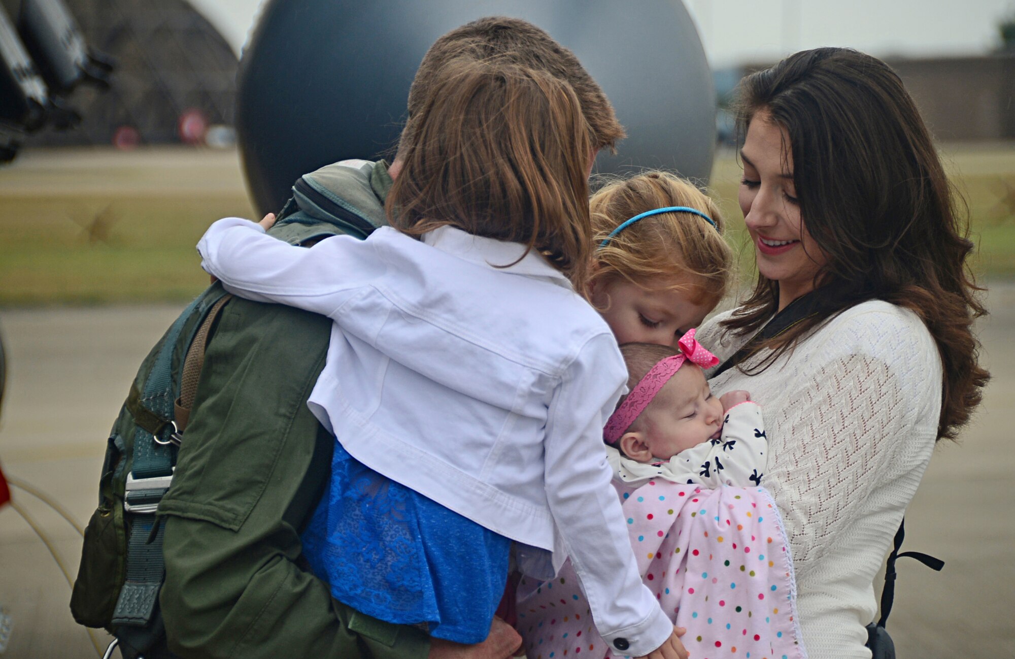Capt. Matthew Gardner, 494th Fighter Squadron F-15E Strike Eagle fighter pilot, greets his family on the flightline at Royal Air  Force Lakenheath, England, Aug. 25, 2014, after returning from  exercises in the U.S. Red Flag is an advanced training program and provides participants with valuable training in planning and executing a wide-variety of combat missions. (U.S. Air Force photo by Airman 1st Class Erin O’Shea/Released) 