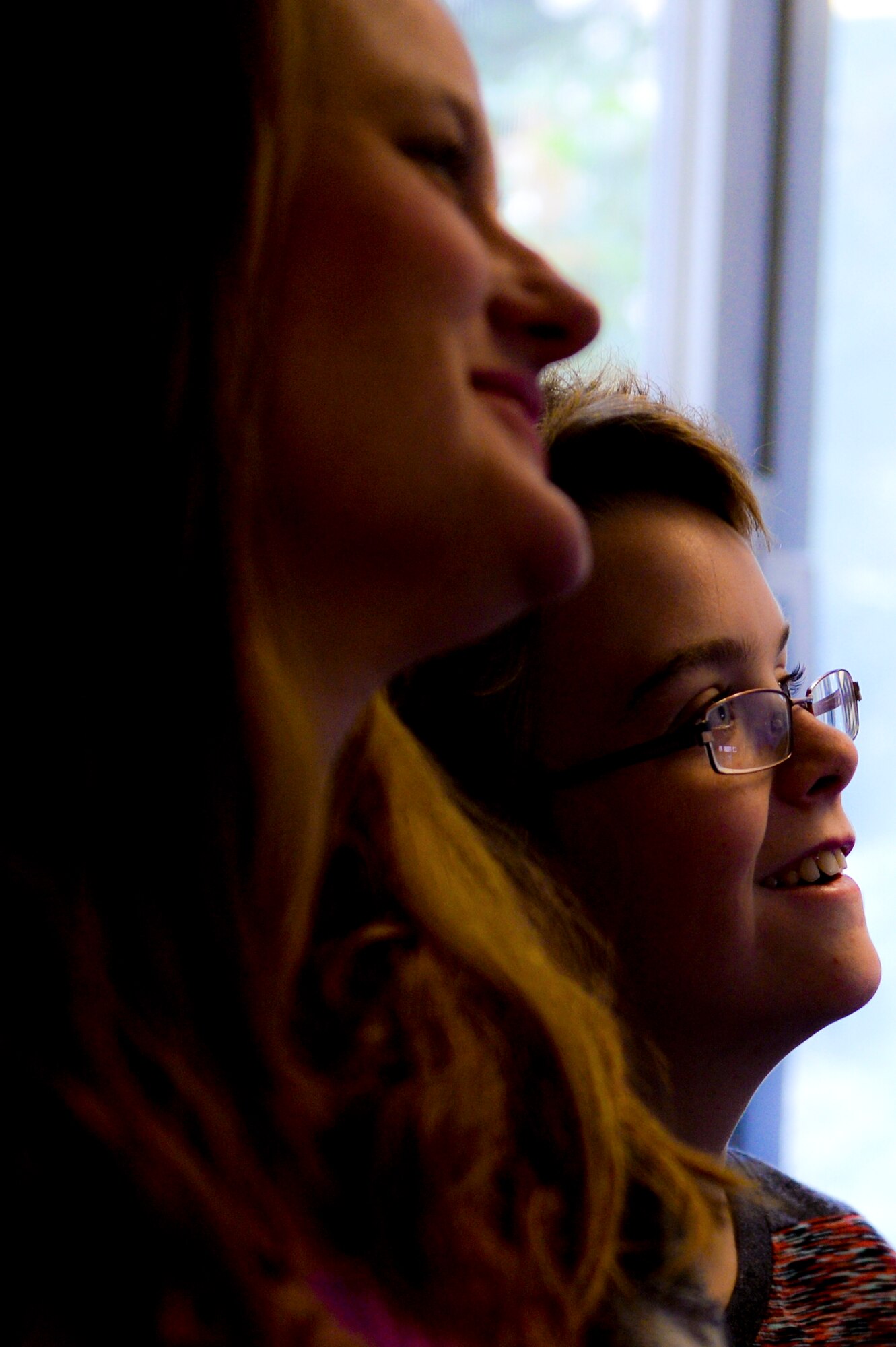 Gavin Lerch, a 7th grade student at Bitburg Middle-High School, son of Bernadette and U.S. Air Force Master Sgt. Martin Lerch, 52nd Force Support Squadron first sergeant, right, smiles as he listens during a tour of Bitburg MHS at Bitburg Annex, Germany, Aug. 22, 2014. Lerch attended the Student 2 Student orientation meeting at the school before the start of the new school year. (U.S. Air Force photo by Airman 1st Class Timothy Kim/Released)