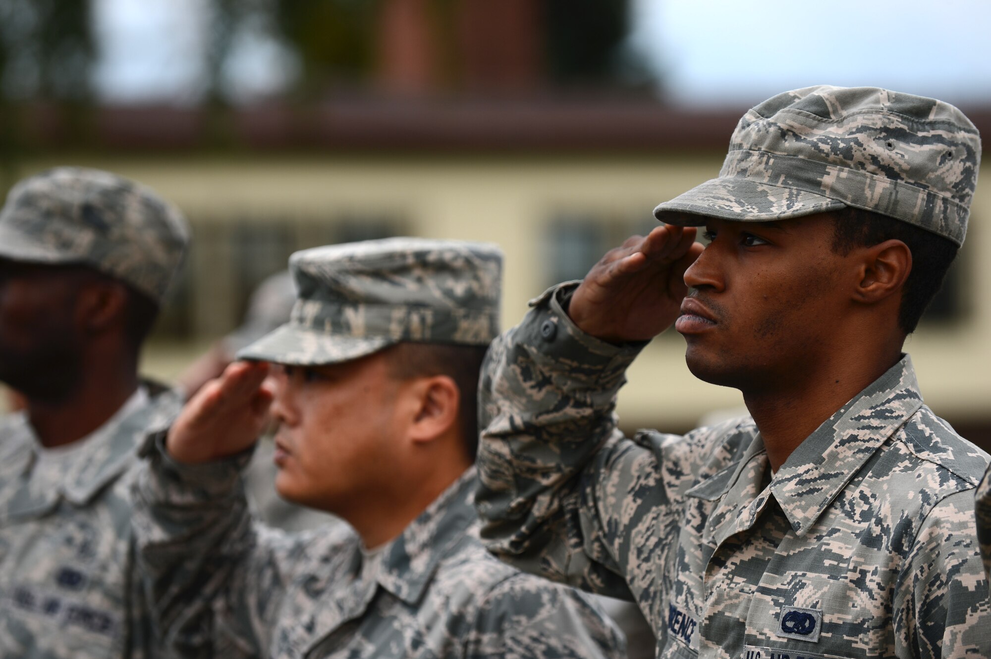 Airmen of the 52nd Fighter Wing salute the American flag during a retreat ceremony at Spangdahlem Air Base, Germany, Aug. 25, 2014.  Each group from the 52nd FW participated in the ceremony. (U.S. Air Force photo by Airman 1st Class Luke J. Kitterman/Released)