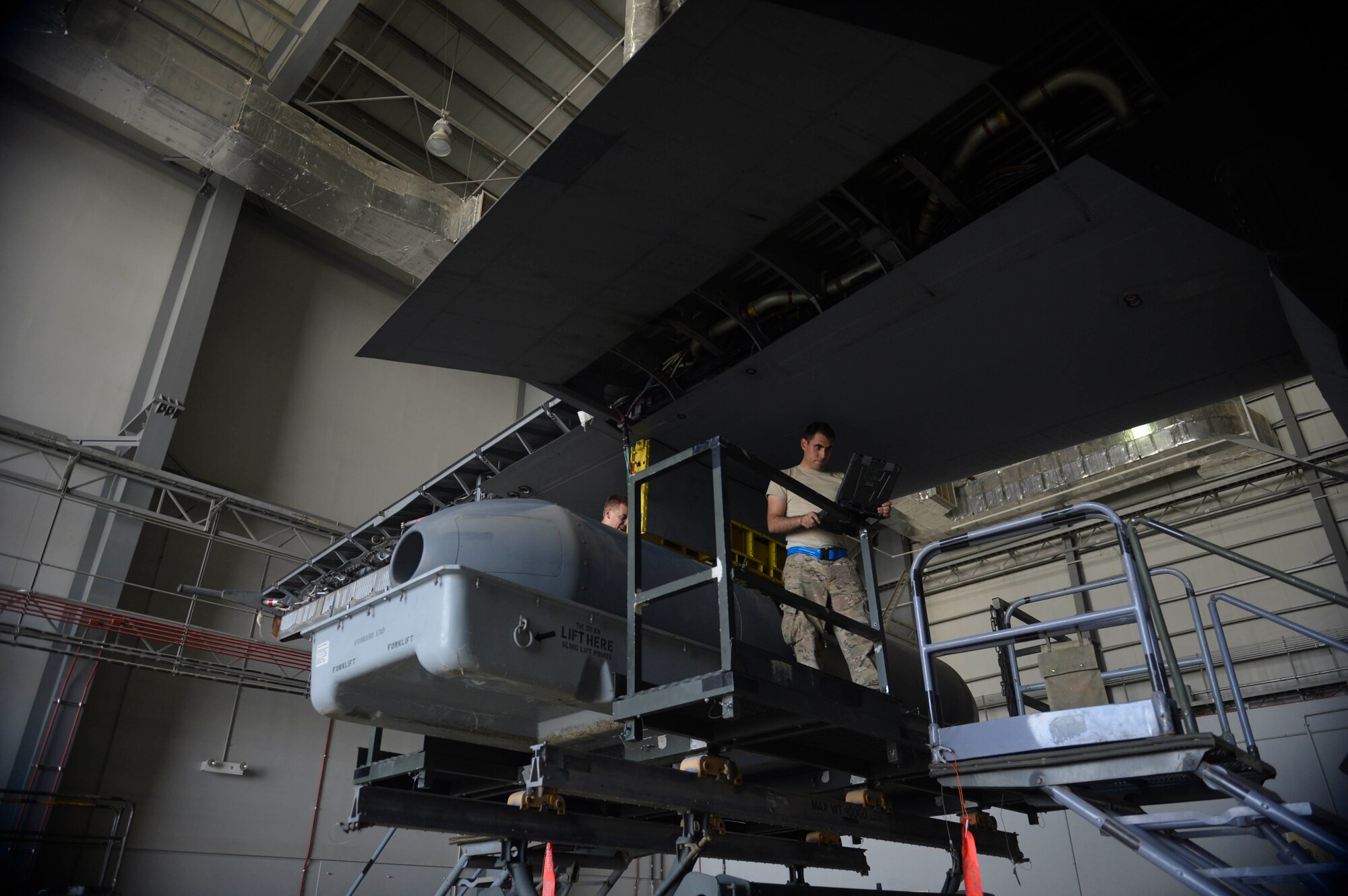 U.S. Air Force Senior Airman Jason Panian, 41st Expeditionary Electronic Combat Squadron electronic warfare systems journeyman, performs maintenance on an EC-130H Compass Call aircraft at Bagram Airfield, Afghanistan Aug. 25, 2014. The EC-130H Compass Call aircraft, a modified version of the C-130, provides electronic warfare protection to ground troops.  (U.S. Air Force photo by Staff Sgt. Evelyn Chavez/Released)