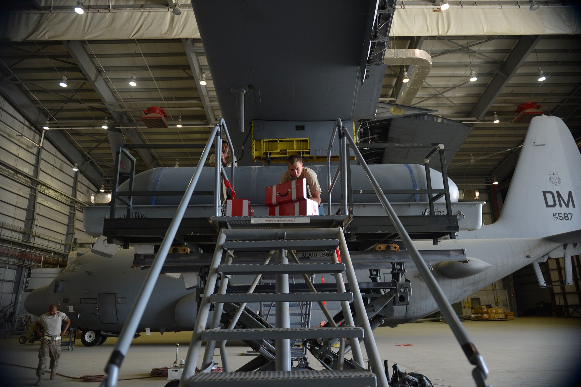 U.S. Air Force Senior Airman Jessie Mechling, 41st Expeditionary Electronic Combat Squadron electronic warfare systems journeyman, gathers tools for maintenance on an EC-130H Compass Call aircraft Bagram Airfield, Afghanistan Aug. 25, 2014.  The unit is deployed from Davis-Monthan Air Force Base, Ariz., and flies the EC-130H Compass Call aircraft whose primary mission is disruption of enemy command and control communications and limiting adversary coordination essential for enemy force management. (U.S. Air Force photo by Staff Sgt. Evelyn Chavez/Released) 