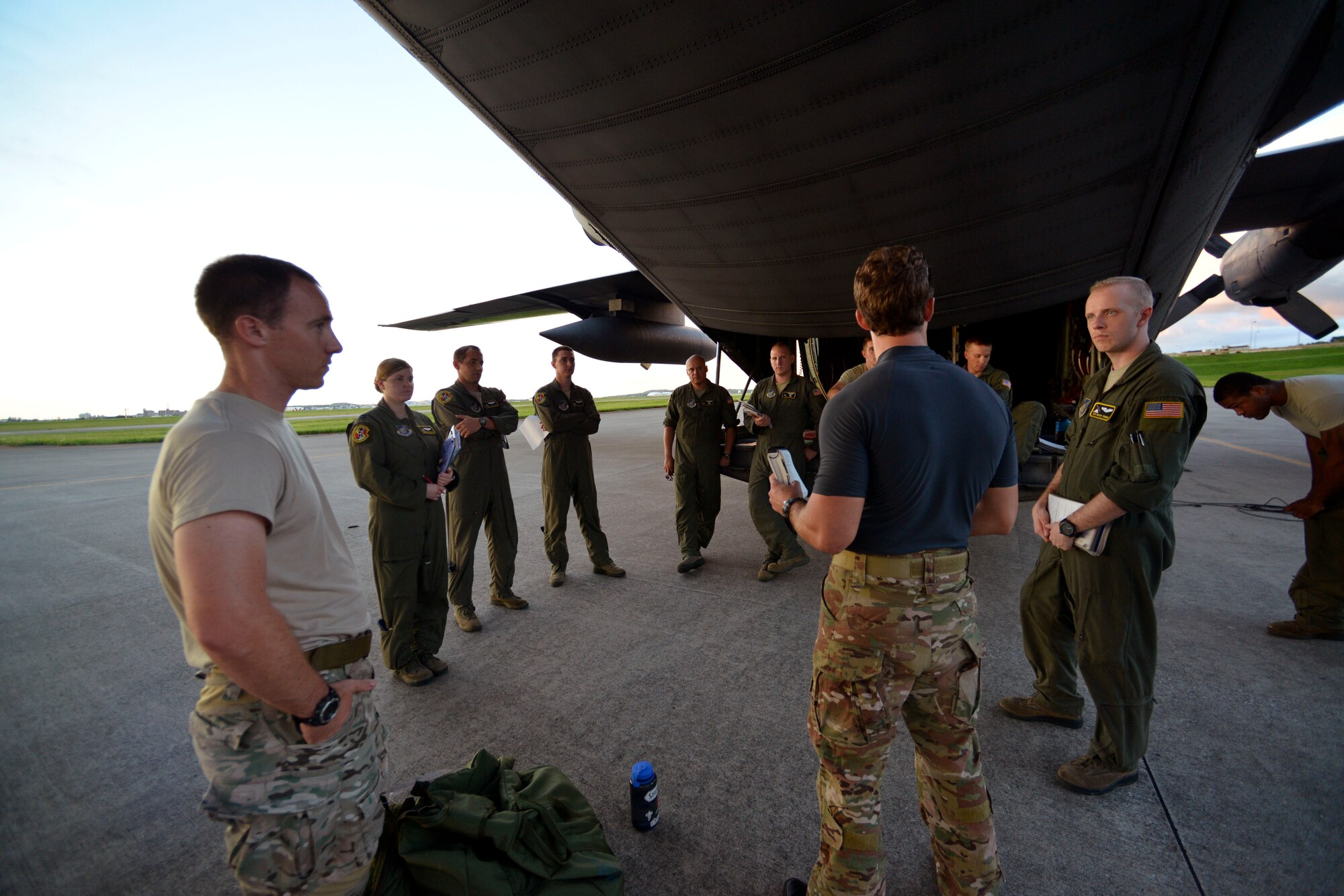 Crew members from the 36th Airlift Squadron, at Yokota Air Base, Japan, receive a briefing from 31st Rescue Squadron pararescuemen from Kadena Air Base, Okinawa, before take-off on Aug. 25, 2014.  The 36th Airlift Squadron provided airlift support to the 31st Rescue Squadron while they conducted training jumps from the aircraft.  (U.S. Air Force photo by Tech. Sgt. Melissa Mekpongsatorn/released)