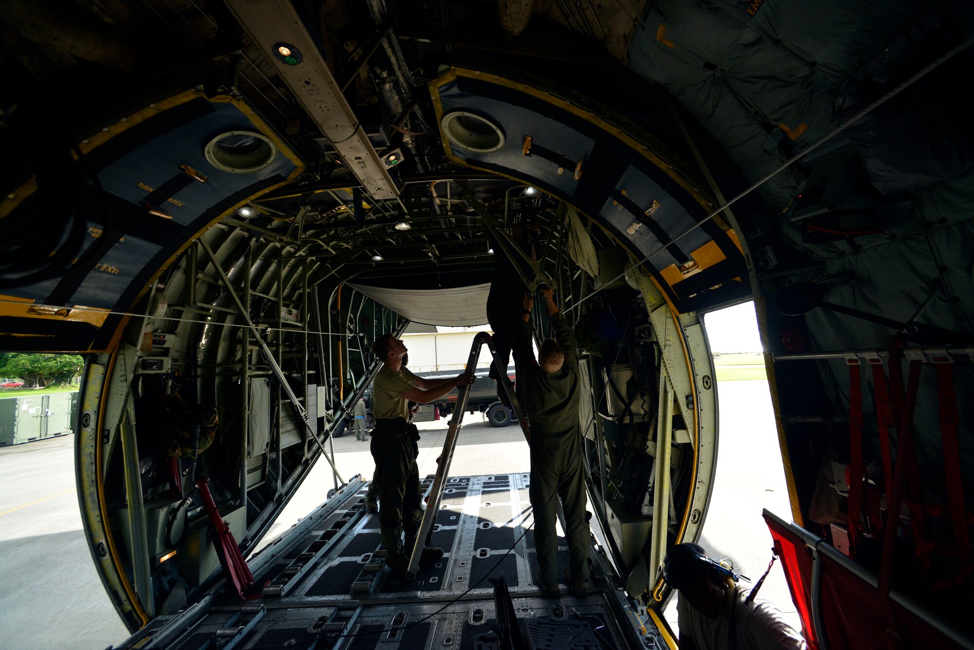 Loadmasters from the 36th Airlift Squadron at Yokota Air Base, Japan, prepare a C-130 Hercules for static line jumping on Aug. 25, 2014.  Yokota Airmen trained alongside members of the 31st Rescue Squadron at Kadena Air Base, Okinawa, to stay current on deployment requirements and upgrade training.  (U.S. Air Force photo by Tech. Sgt. Melissa Mekpongsatorn/released)