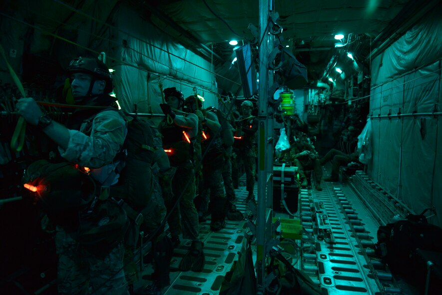 Pararescuemen from the 31st Rescue Squadron at Kadena Air Base, Okinawa, prepare for a training jump into the ocean on Aug. 25, 2014.  The Airmen jumped from a Yokota Air Base, Japan, C-130 Hercules, that provided the aerial platform for the training.  (U.S. Air Force photo by Tech. Sgt. Melissa Mekpongsatorn/released)