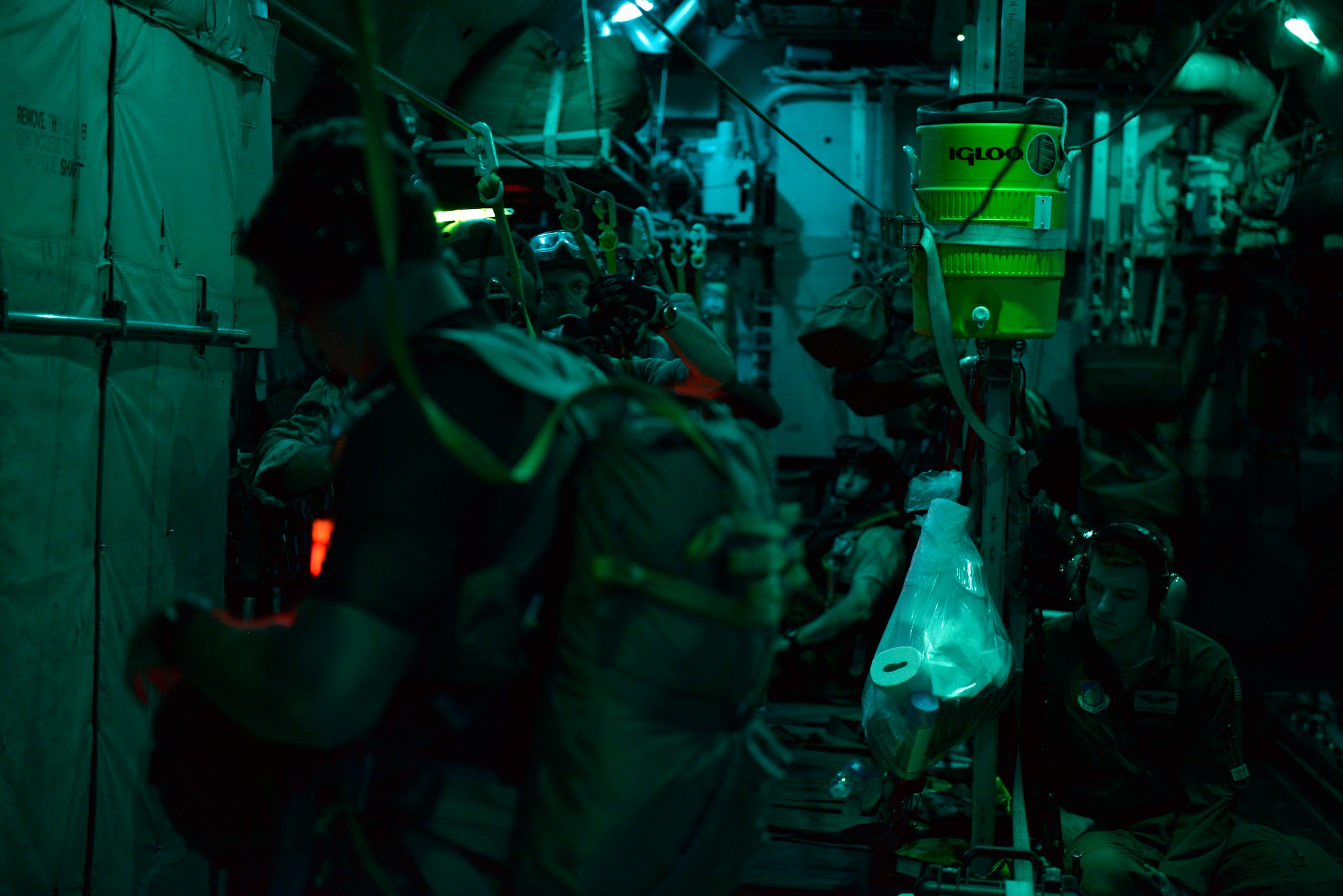 Pararescuemen from the 31st Rescue Squadron at Kadena Air Base, Okinawa, prepare for a training jump into the ocean on Aug. 25, 2014.  The Airmen jumped from a Yokota Air Base, Japan, C-130 Hercules, that provided the aerial platform for the training.  (U.S. Air Force photo by Tech. Sgt. Melissa Mekpongsatorn/released)