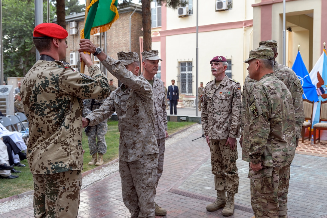 U.S. Marine Corps Sgt. Maj. James E. Booker, second from left, takes the command flag as U.S. Marine Corps Gen. Joseph H. Dunford Jr., commander of U.S. and NATO forces in Afghanistan; German ArGen. Hans-Lothar Domröse, commander of Joint Force Command Brunssum; U.S. Army Gen. Lloyd J. Austin III, commander of U.S. Central Command; and U.S. Army Gen. John F. Campbell look on during the change-of-command ceremony for NATO's International Security Assistance Force in Kabul, Afghanistan, Aug. 26, 2014. Campbell, former Army vice chief of staff, assumed command from Dunford.