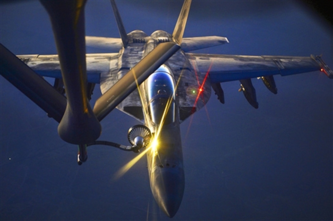 A U.S. F-18 fighter jet refuels from a U.S. Air Force KC-135 Stratotanker aircraft over northern Iraq, Aug. 21, 2014.