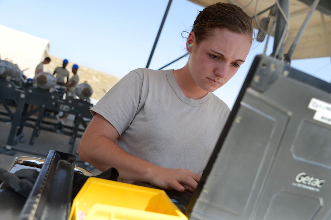 Munitions Systems Technician assigned to 455th Expeditionary Maintenance Squadron reviews technical data before building GBU-38 bomb, part of weapon system used on F-16C Fighting Falcons, August 14, 2014 (U.S. Air Force/Cohen A. Young)