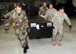 A container holding equipment belonging to Texas Task Force One is being prepared for air transport by members of the 147th Reconnaissance Wing of the Texas Air National Guard, based at Ellington Field Joint Reserve Base in Houston Texas Jan. 14, 2010.