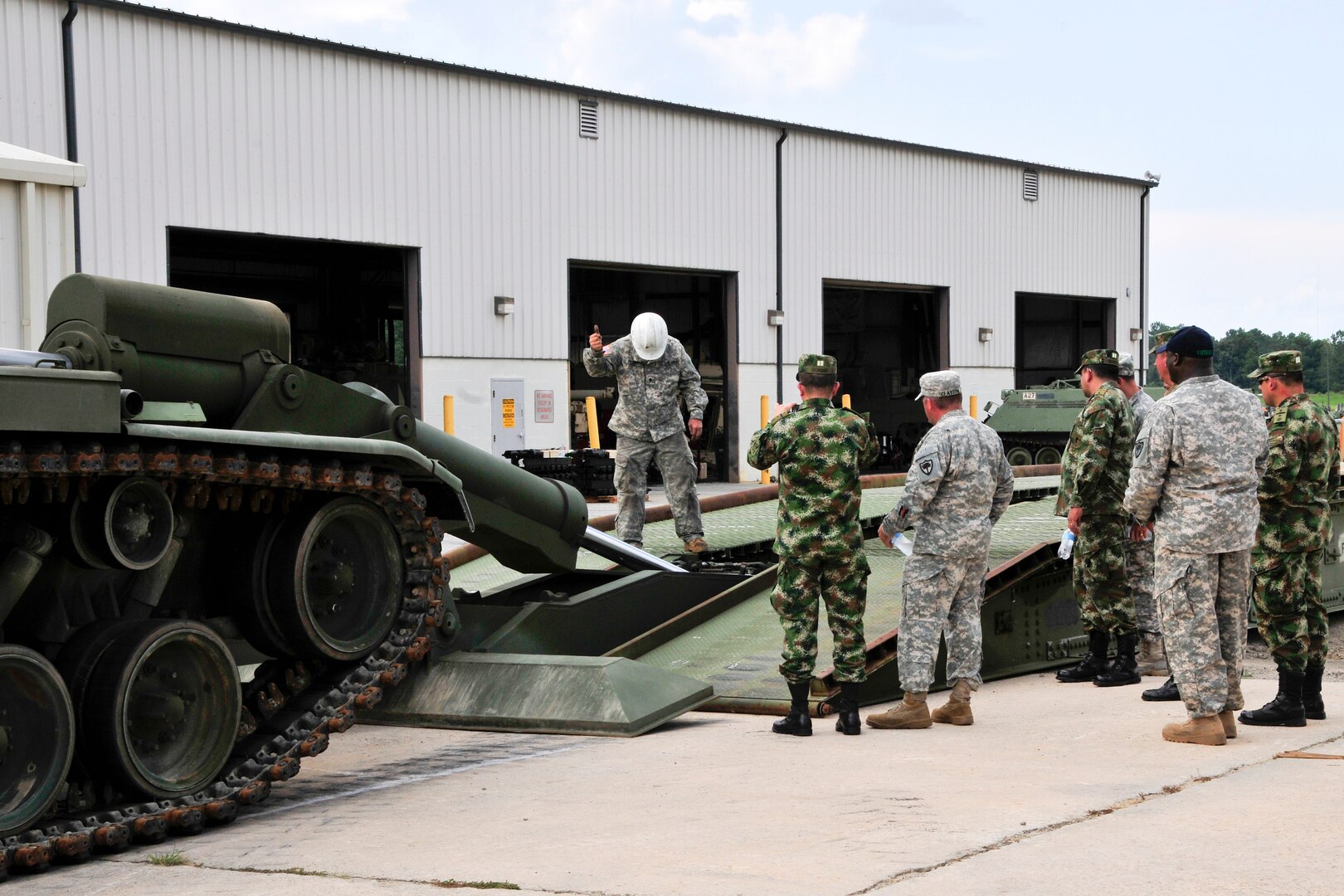 South Carolina Army National Guard Soldiers share maintenance procedures during a visit by a team of Colombian army maintenance and logistics leaders as part of the State Partnership Program between the S.C. National Guard and Colombia, in Eastover, S.C., Aug. 18-22, 2014. 