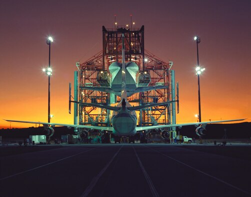Evening light begins to fade at NASA's Ames-Dryden Flight Research Facility (later redesignated Armstrong Flight Research Center), Edwards, Calif., as technicians begin the task of mounting the Space Shuttle Atlantis atop NASA's 747 Shuttle Carrier Aircraft for the ferry flight back to the Kennedy Space Center, Fla., following its STS-44 flight Nov. 24 through Dec. 1, 1991. After 38 years, the grey-colored space shuttle Mate-Demate Device (MDD) at Edwards Air Force Base is being dismantled and demolished as a part of the final chapter in the U.S. space shuttle program. (NASA courtesy photo)