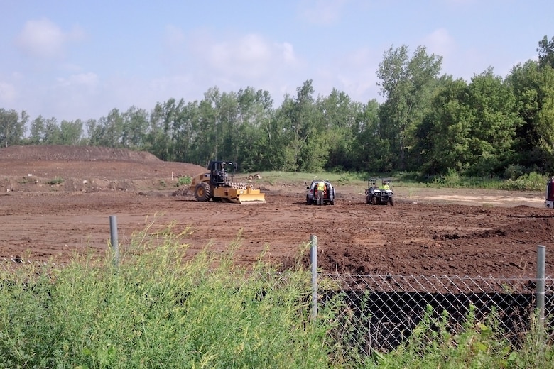 Contractors work to consolidate waste and create a soil cover at the Lockbourne landfill in Columbus, Ohio.