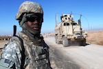 Master Pfc. Quintavis B. Byrd, a gate sentinel from the Mississippi National Guard, watches gun trucks pass the main entry control point of Contingency Operating Location Q-West, Jan. 10. Byrd serves with A Company, 2nd Battalion, 198th Combined Arms, 155th Brigade Combat Team, a mechanized infantry unit out of Hernando, Miss., that provides force protection to Q-West. This day marked the unit's sixth month of ECP operations. There have been no security breaches during their tenure.