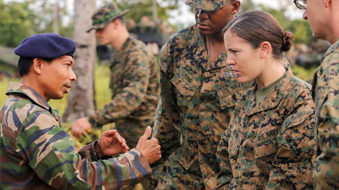 A medical team with Combat Logistics Battalion 11, 11th Marine Expeditionary Unit, listens to a member of the Malaysian Armed Forces during Malaysia-United States Amphibious Exercise 2014 at Kg Tanduo, Malaysia. The exercise is designed to allow the 11th MEU to work with the Malaysian Armed Forces to hone their amphibious capabilities by conducting rehearsals with ship-to-shore connectors and utilizing the rapid response planning processes.

