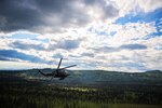 An Alaska Air National Guard HH-60 Pave Hawk, from the 210th Rescue Squadron, performs a simulated search and rescue pattern near the Little Susitna River in Alaska. 