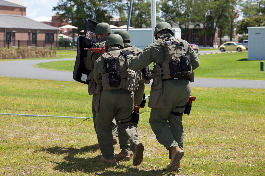 Members of a Special Response Team prepare to enter a building as part of a training exercise at Marine Corps Air Station Cherry Point, N.C., August 26, 2014. 
The training simulated an active-shooter scenario and hostage situation to help members of Cherry Point's law enforcement train and prepare for real life scenarios.
The exercise also helped Cherry Point and 2nd Marine Aircraft Wing validate the air station's active-shooter response plan.