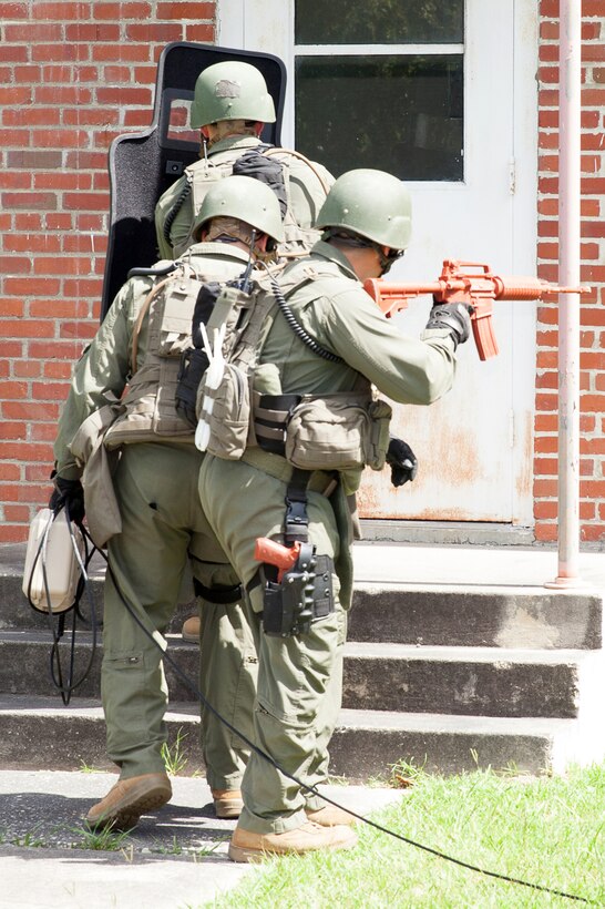 Members of a Special Response Team deliver a telephone during a simulated hostage situation as part of a training exercise at Marine Corps Air Station Cherry Point, N.C., August 26, 2014. 
The training simulated an active-shooter scenario and hostage situation to help members of Cherry Point's law enforcement train and prepare for real life scenarios. The exercise also helped Cherry Point and 2nd Marine Aircraft Wing validate the air station's active-shooter response plan.