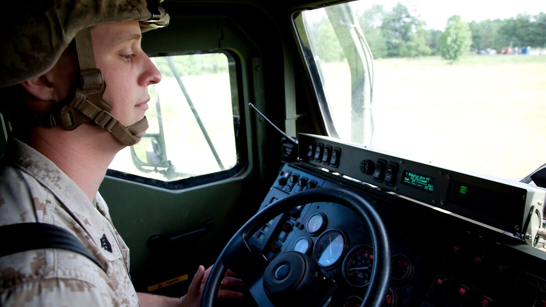 Sgt. Brandon M. Frongillo, a motor vehicle operator with 2nd Tank Battalion, 2nd Marine Division, II Marine Expeditionary Force, supervises the autonomous mobile applique system as it operates a 7-ton tactical vehicle during the Autonomous Mobility Applique System Joint Capability Technology Demonstration Aug. 20, 2014, at the Savannah River Site in Aiken, South Carolina. The AMAS can both assist drivers or warn them of upcoming danger. The system can be controlled manually or through remote control. 
