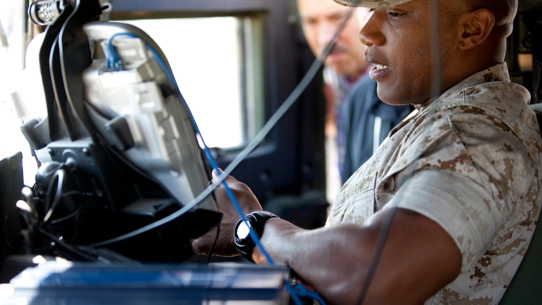 Staff Sgt. Maurice Mincey, a motor transport operations chief with Combat Logistics Battalion 2, Combat Logistics Regiment 2, 2nd Marine Logistics Group, II Marine Expeditionary Force, operates a remote control system during the Autonomous Mobility Applique System Joint Capability Technology Demonstration Aug. 20, 2014, at the Savannah River Site in Aiken, South Carolina. The remote control is designed to operate tactical vehicles with the assistance of the AMAS without being in a convoy, leaving the personnel in the convoy to supervise the system’s actions. 