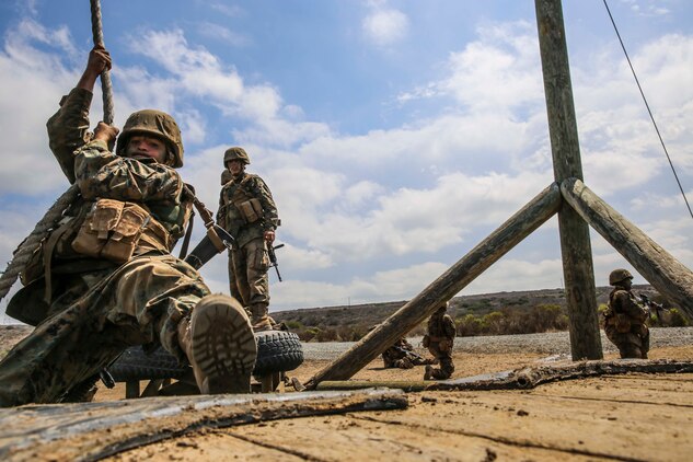 A recruit from Mike Company, 3rd Recruit Training Battalion, attempts to swing to a platform during Gonzalez’s Challenge at Marine Corps Base Camp Pendleton, Calif., Aug. 20. Gonzalez’s Challenge is one of many exercises recruits are required to perform during the Crucible, a 54-hour exercise that is the final test of recruit training.