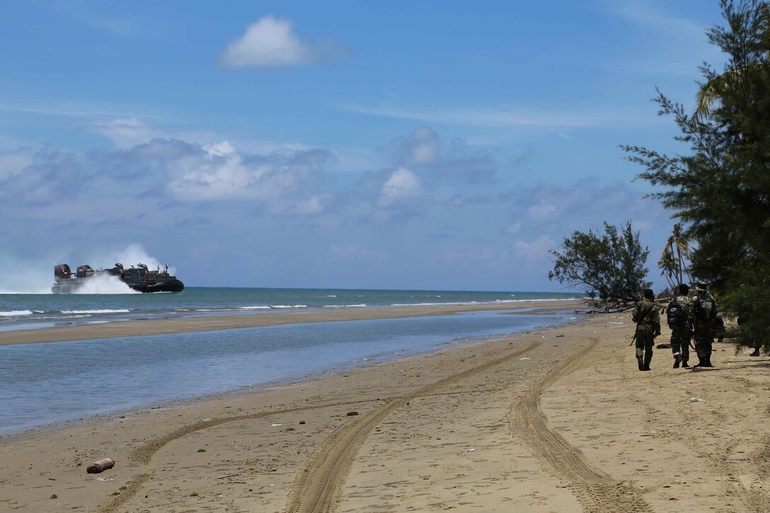 Members of the Malaysian Armed Forces comb a beach for debris prior to the landing of a landing craft air cushion carrying Marines and sailors from the 11th Marine Expeditionary Unit and Amphibious Squadron Five at the beginning of Malaysia-United States Amphibious Exercise 2014. MALUS AMPHEX 14 is a bilateral exercise between the 11th MEU and Malaysian Armed Forces designed to foster and sustain cooperative and international relationships with emphasis on amphibious and humanitarian operations within the context of a stability and security operation. (U.S. Marine Corps photo by 1st. Lt. Colleen McFadden/RELEASED)