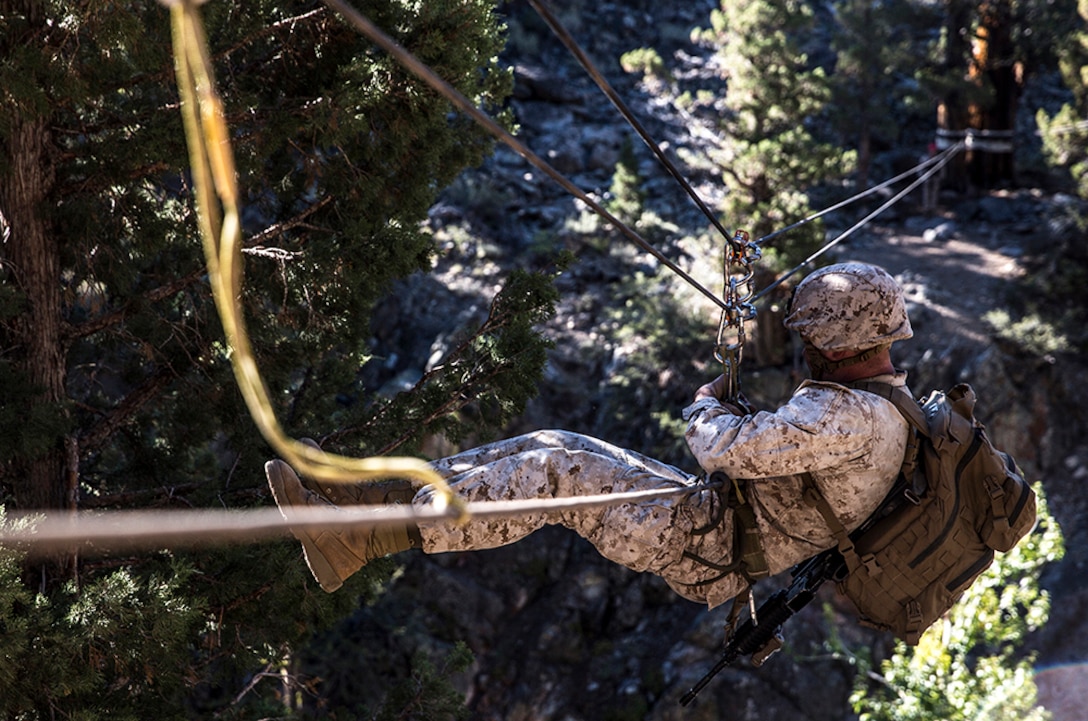 U.S. Marine 2nd Lt. Hunter Harrison makes his way across a gorge suspended more than 100 feet above ground while training to build and cross rope bridges during Mountain Exercise 2014 aboard Marine Corps Mountain Warfare Training Center in Bridgeport, Calif., Aug. 27, 2014. Harrison is a platoon commander with 2nd Platoon, India Company, 3rd Battalion, 1st Marine Regiment. Marines with 3rd Battalion, 1st Marine Regiment will become the 15th Marine Expeditionary Unit’s ground combat element in October. Mountain Exercise 2014 develops critical skills the battalion will need during deployment.