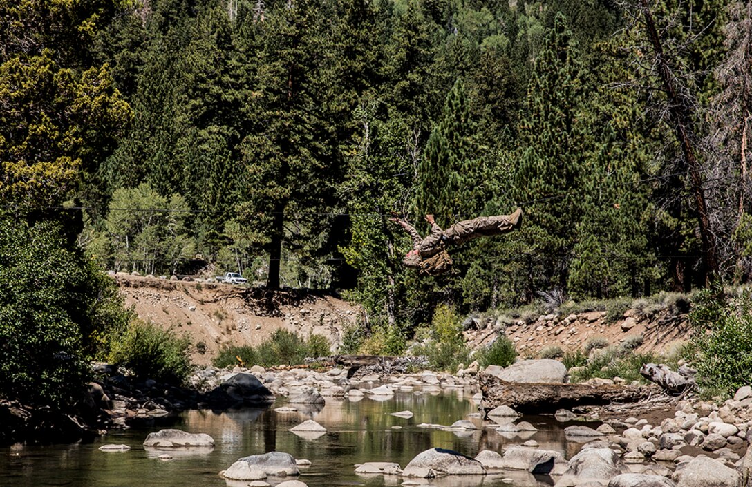 U.S. Marine Lance Cpl. Eric Mercado makes his way across a river while training to build and cross rope bridges during Mountain Exercise 2014 aboard Marine Corps Mountain Warfare Training Center in Bridgeport, Calif., Aug. 27, 2014. Mercado is an infantry assaultman with 2nd Platoon, India Company, 3rd Battalion, 1st Marine Regiment. Marines with 3rd Battalion, 1st Marine Regiment will become the 15th Marine Expeditionary Unit’s ground combat element in October. Mountain Exercise 2014 develops critical skills the battalion will need during deployment. 