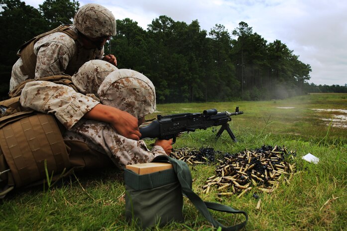 Sgt. Cody Refior, left, observes Lance Cpl. Andy Jimenez, middle, and Lance Cpl. John Rueda while they fire a M-240B machine gun at Marine Corps Base Camp Lejeune, N.C., Aug. 25, 2014. Refior is an automotive maintenance technician, and Jimenez and Rueda are air support operations operators with the squadron.