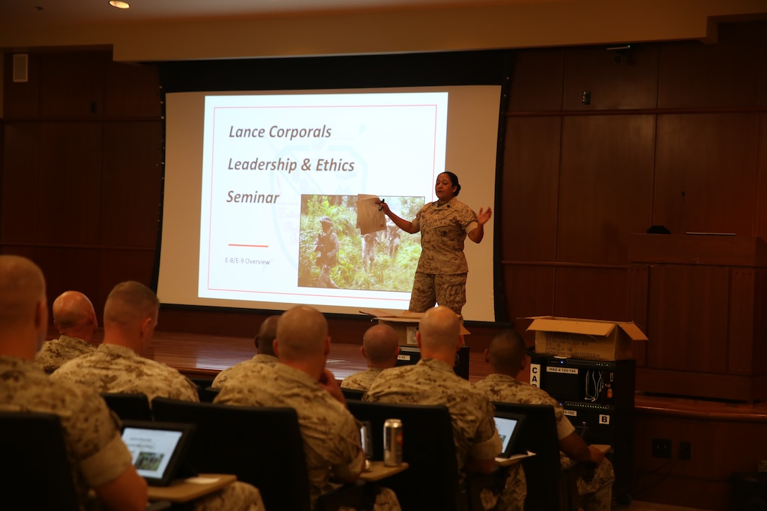 Sgt. Maj. Laura L. Brown, Marine Corps University Enlisted Professional Military Education Adviser, explains the principles of the newly implemented Lance Corporal Leadership and Ethics Seminar in the Marine Corps Support Facility New Orleans auditorium, Aug. 27, 2014. The train-the-trainer course was designed to inform senior enlisted advisors on the new Lance Corporal Leadership Ethics Seminar implemented throughout the Marine Corps. The seminar was implemented to assist lance corporals of the resources available to them, as well as motivate them to succeed and strive for the next rank.  